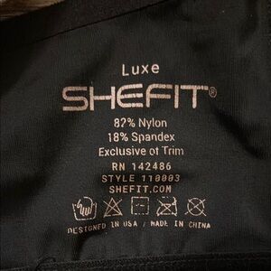 SHEFIT Luxe Black and rose gold sports bra.